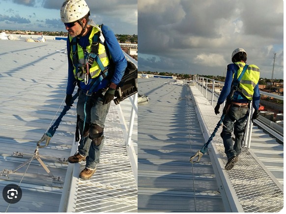 Instalação de linha de vida em telhado industrial — equipe com cinto de segurança e ancoragem